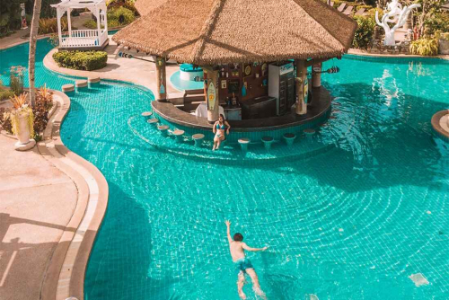 Thavorn Palm Beach Resort Phuket’s pool with a swim-up bar